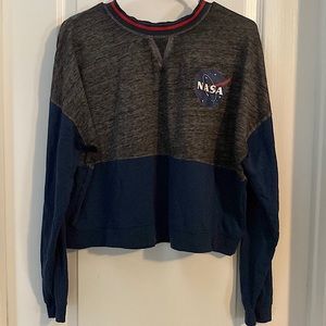 Gray, blue, and red colored long sleeve nasa shirt